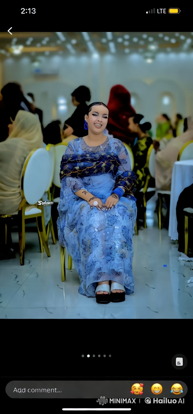Elegant Woman in Blue Floral Gown at Lavish Event