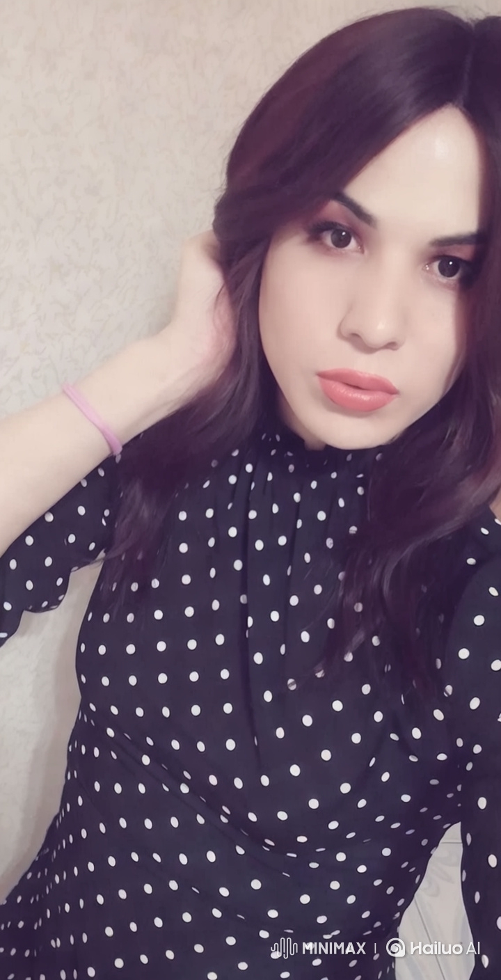 Elegant Woman in Polka Dot Dress with Graceful Pose