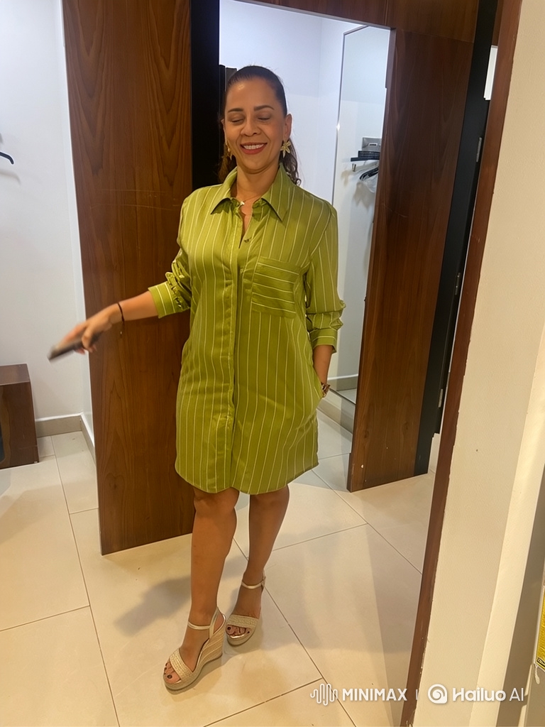 Woman Struts Confidently Down Hallway in Chic Dress