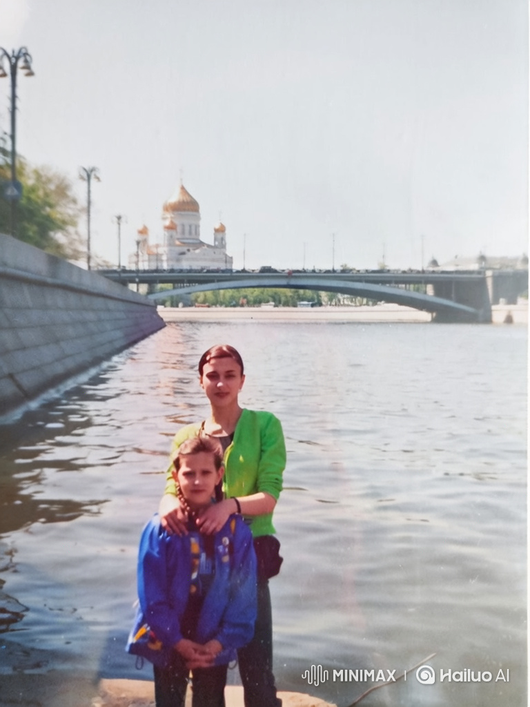 Woman and Girl by River with Cathedral in Background