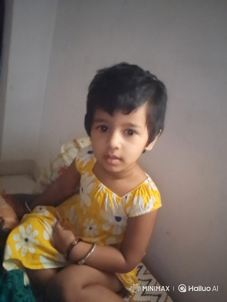 Young Girl in Yellow Dress with Calm, Curious Expression