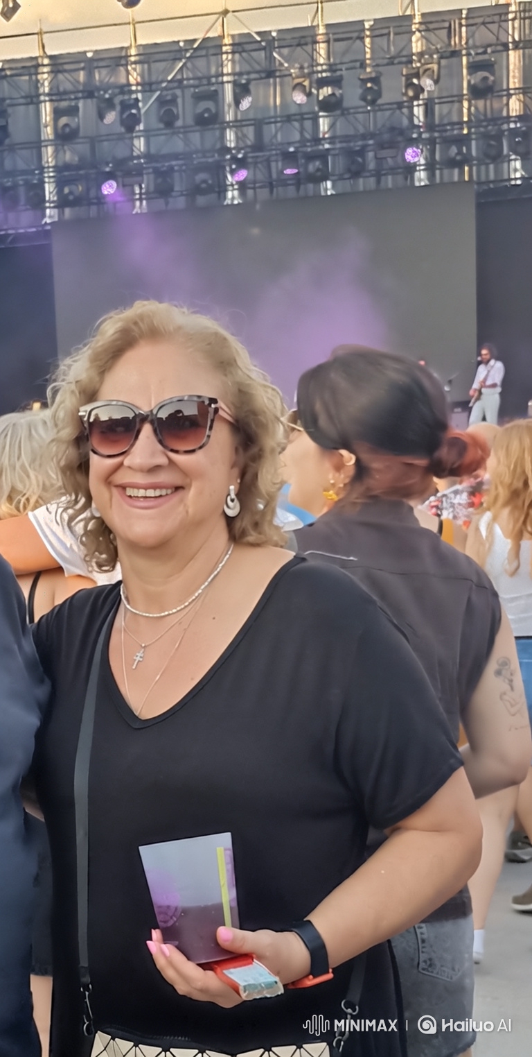 Middle-Aged Woman Enjoying Live Concert and Dancing
