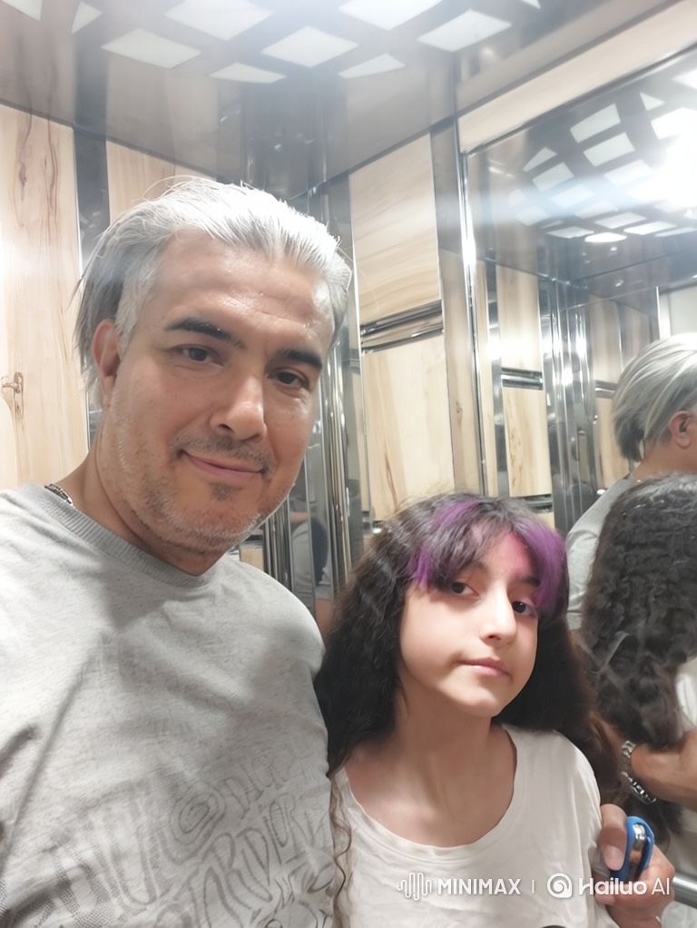 Father and Daughter Embrace in Elevator