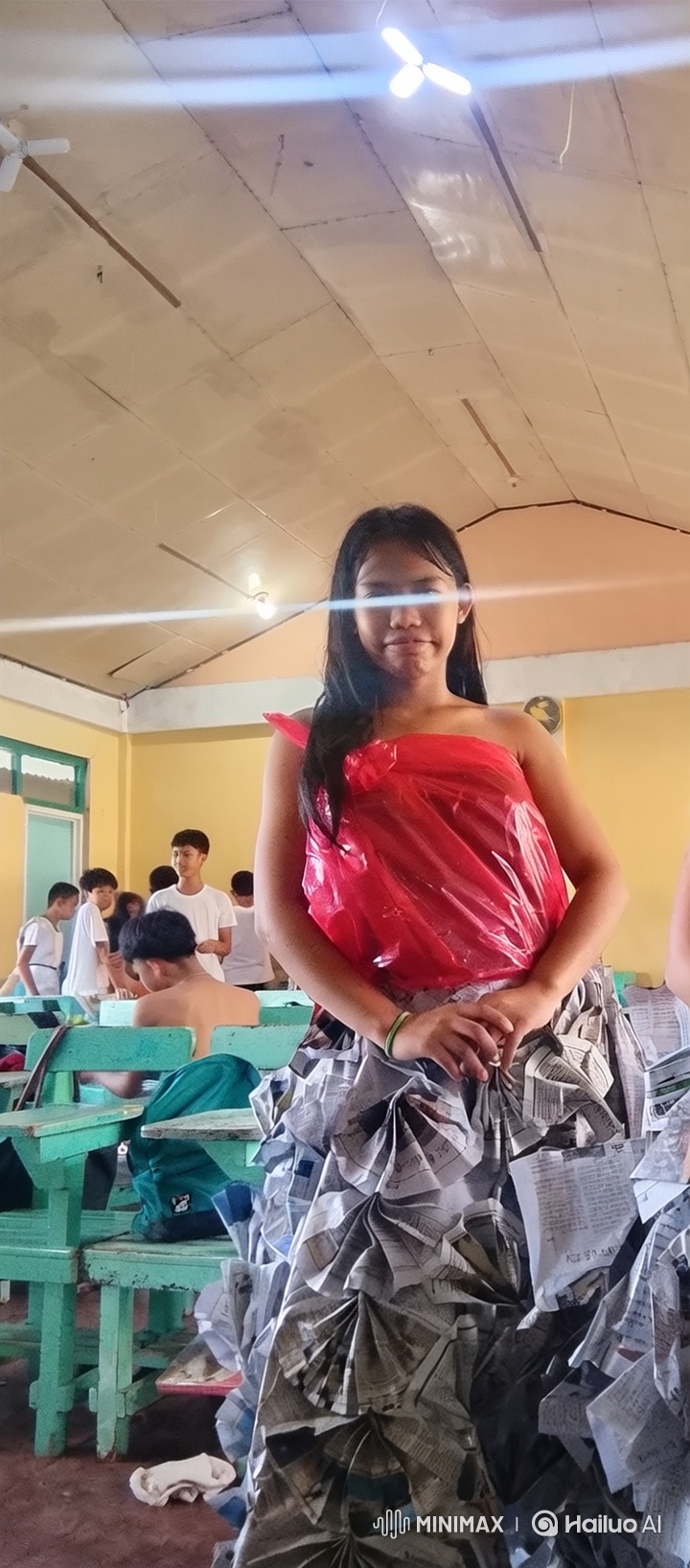 Young Girl Models Innovative Newspaper Dress in Classroom