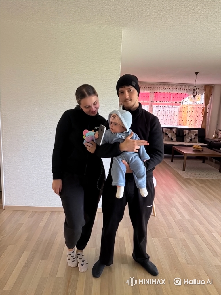 Family Moment: Father Rocks, Mother Entertains Baby