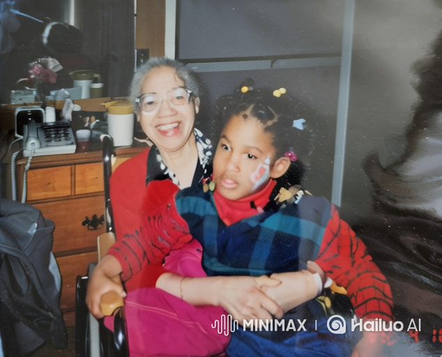 Elderly Asian Woman and Young Black Girl Share Intimate Moment