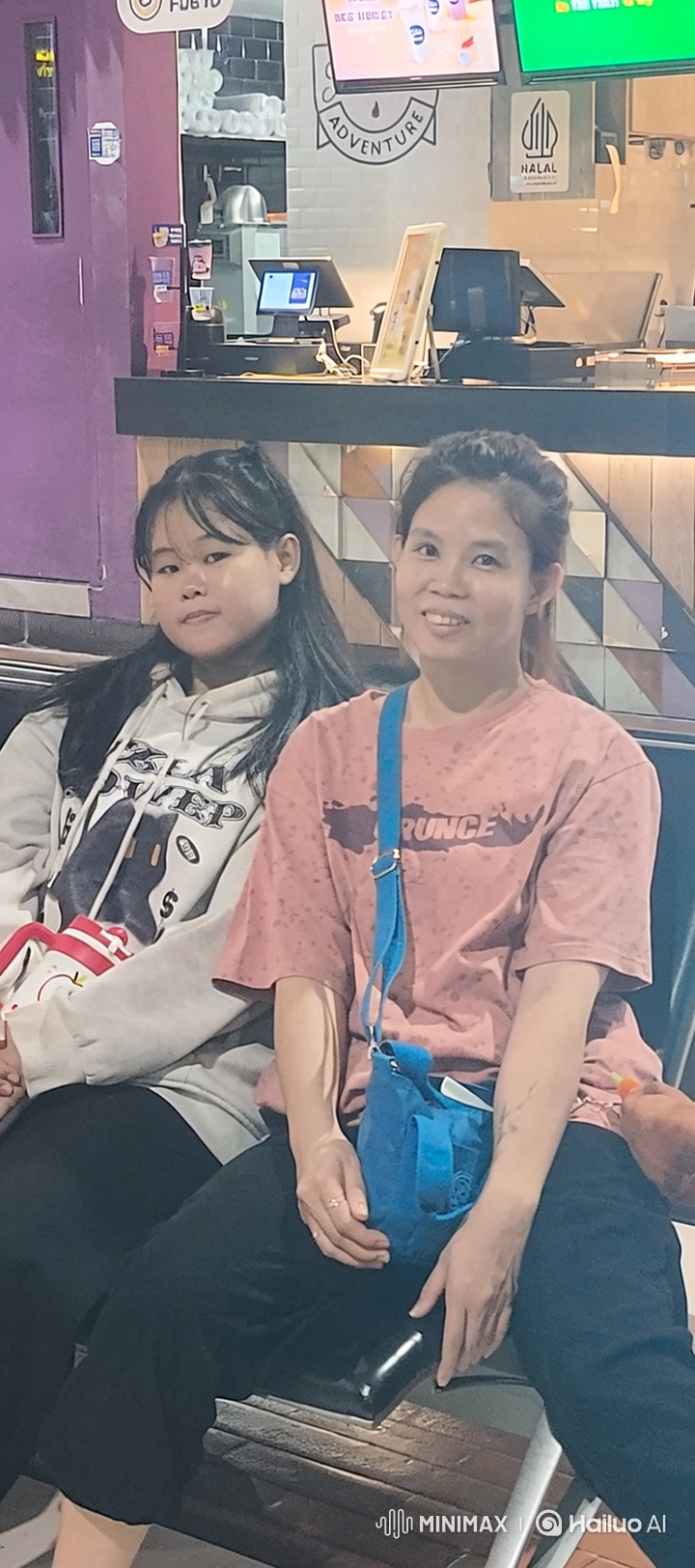 Mother and Daughter Share Tender Moment in Eatery