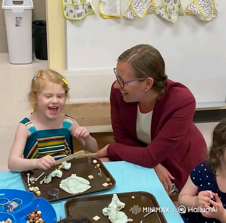 Girl and Woman Share Joyful Moment in Classroom Craft Activity