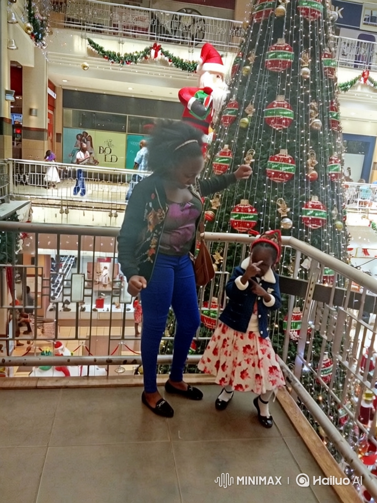 Woman and Girl Dance Joyfully by Christmas Tree