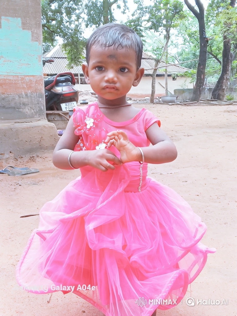 Young Girl in Pink Dress Twirls in Rural Yard