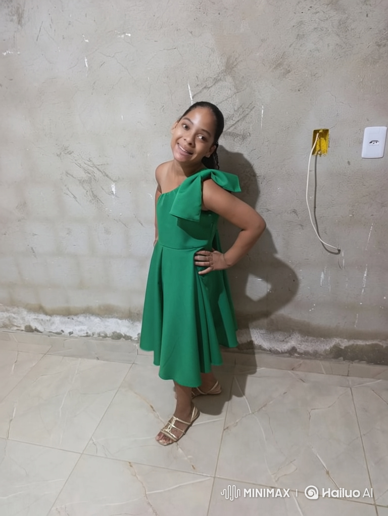 Woman in Green Dress Gracefully Dances for Camera